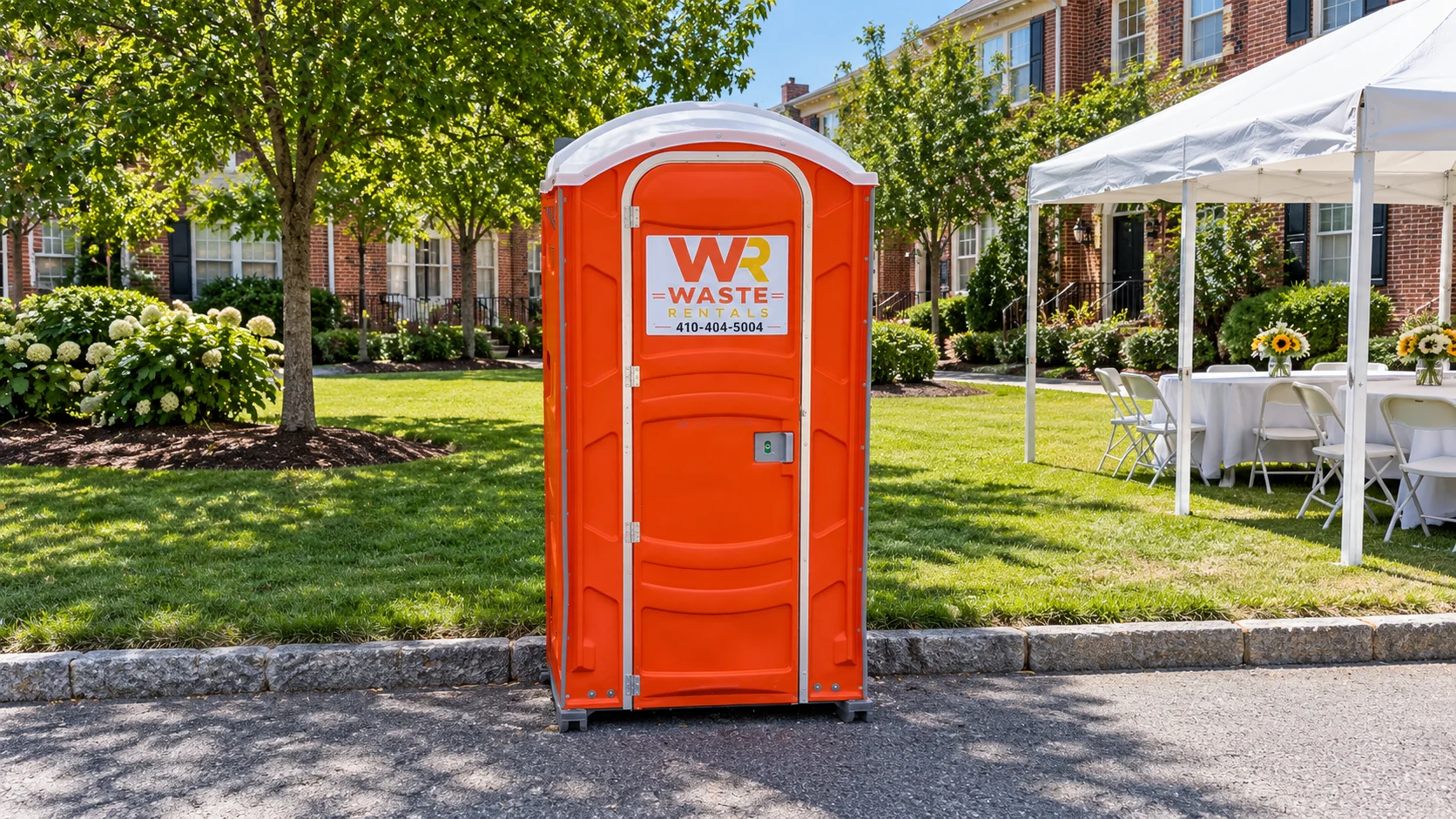 Orange Waste Rentals portable toilet beside a neighborhood event lawn and white canopy